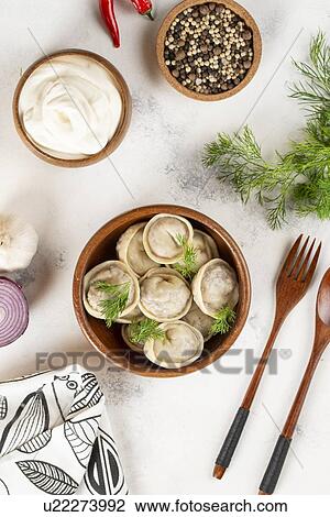 Stock Image - Dumplings in bowl with dill. Fotosearch