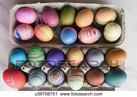 Stock Image - Dyed eggs in carton. Fotosearch