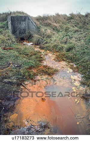 Effluent contaminated with heavy metals from buried waste, draining into river Thame, West Midlands, UK View Large Photo Image Stock Image - Effluent contaminated with heavy metals from buried waste, draining into river Thame, West Midlands, UK. Fotosearch