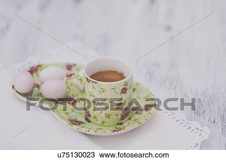 Stock Image - Eggs on floral plate with matching cup of tea. Fotosearch