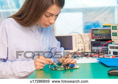 Stock Photo - Engineer working on circuit board.. Fotosearch