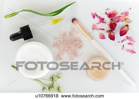 Stock Photo - Eyeshadow, skin care products and flowers. Fotosearch