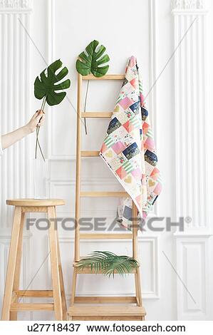 Fabric on rack with palm leaves View Large Photo Image Stock Photo - Fabric on rack with palm leaves. Fotosearch