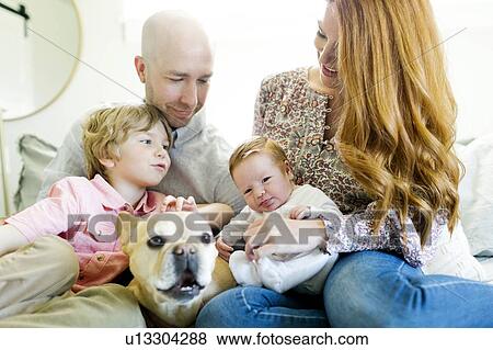 Family and their dog on bed View Large Photo Image Stock Photo - Family and their dog on bed. Fotosearch