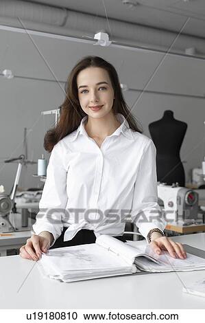 Fashion designer working at desk in studio View Large Photo Image Stock Image - Fashion designer working at desk in studio. Fotosearch