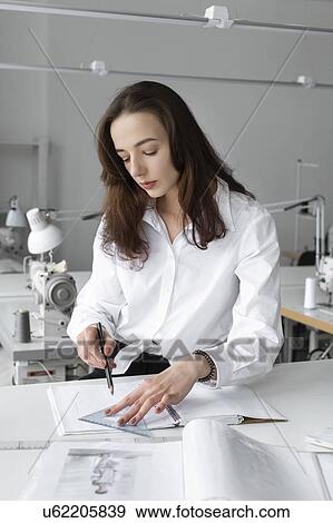 Fashion designer working at desk in studio View Large Photo Image Stock Photo - Fashion designer working at desk in studio. Fotosearch