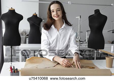 Fashion designer working at desk in studio View Large Photo Image Stock Photo - Fashion designer working at desk in studio. Fotosearch