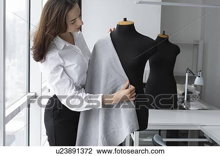 Fashion designer working with dressmaker's model in studio View Large Photo Image Stock Image - Fashion designer working with dressmaker's model in studio. Fotosearch