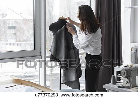 Fashion designer working with dressmaker's model in studio View Large Photo Image Stock Image - Fashion designer working with dressmaker's model in studio. Fotosearch