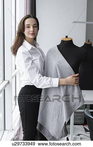 Fashion designer working with dressmaker's model in studio View Large Photo Image Stock Photo - Fashion designer working with dressmaker's model in studio. Fotosearch