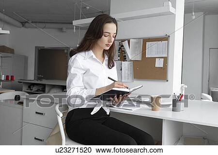Fashion designer writing in notebook View Large Photo Image Stock Image - Fashion designer writing in notebook. Fotosearch