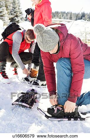 Father and teenage daughters putting on snowshoes, Styria, Tyrol, Austria View Large Photo Image Stock Photo - Father and teenage daughters putting on snowshoes, Styria, Tyrol, Austria. Fotosearch