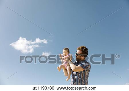 Stock Photograph - Father holding his baby girl. Fotosearch
