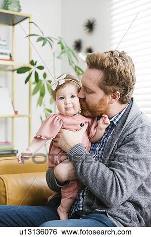 Father kissing his baby daughter's cheek View Large Photo Image Stock Photograph - Father kissing his baby daughter's cheek. Fotosearch