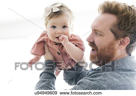 Father lifting his baby girl View Large Photo Image Stock Photo - Father lifting his baby girl. Fotosearch