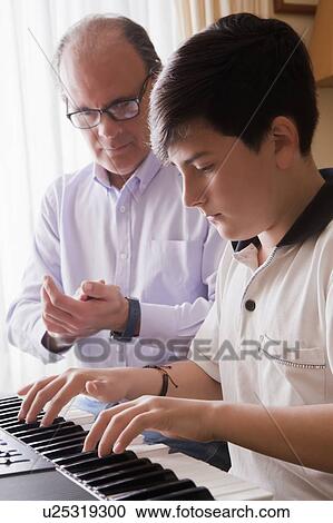 Father teaching his son piano View Large Photo Image Stock Image - Father teaching his son piano. Fotosearch