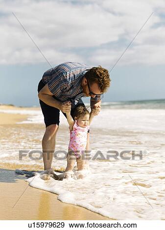 Father with his baby girl on beach View Large Photo Image Stock Photo - Father with his baby girl on beach. Fotosearch
