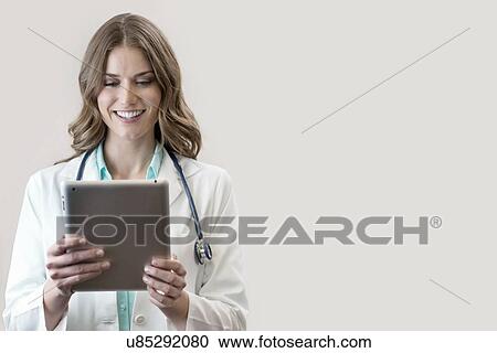 Female doctor holding digital tablet. View Large Photo Image Stock Image - Female doctor holding digital tablet.. Fotosearch