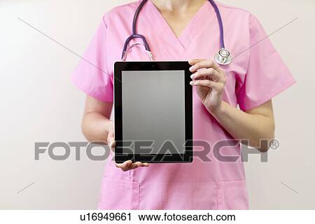 Female nurse holding digital tablet. View Large Photo Image Stock Image - Female nurse holding digital tablet.. Fotosearch