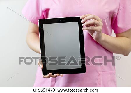 Female nurse holding digital tablet. View Large Photo Image Stock Photo - Female nurse holding digital tablet.. Fotosearch