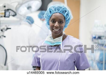 Stock Photography - Female surgeon looking towards camera, portrait.. Fotosearch