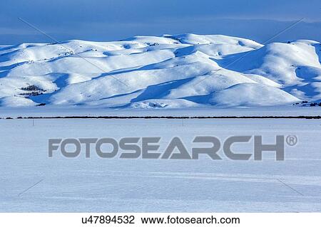 Stock Image - Field and mountain during winter in Fairfield, Idaho. Fotosearch