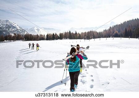 Five teenage girl skiers carrying skis in snow covered landscape, rear view, Tyrol, Styria, Austria View Large Photo Image Stock Photo - Five teenage girl skiers carrying skis in snow covered landscape, rear view, Tyrol, Styria, Austria. Fotosearch