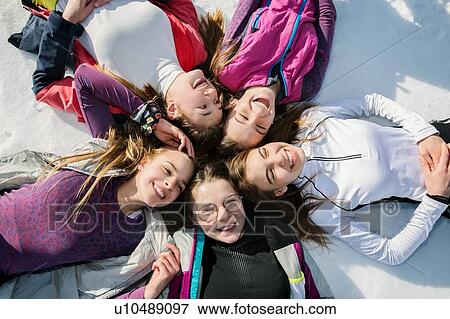 Five teenage girl skiers lying in a circle in snow, overhead view, Tyrol, Styria, Austria View Large Photo Image Stock Photo - Five teenage girl skiers lying in a circle in snow, overhead view, Tyrol, Styria, Austria. Fotosearch