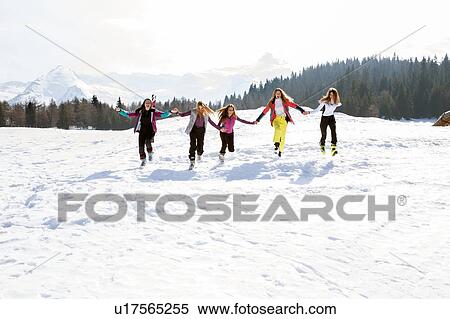 Five teenage girl skiers running and laughing in snow covered landscape, Tyrol, Styria, Austria View Large Photo Image Stock Photography - Five teenage girl skiers running and laughing in snow covered landscape, Tyrol, Styria, Austria. Fotosearch