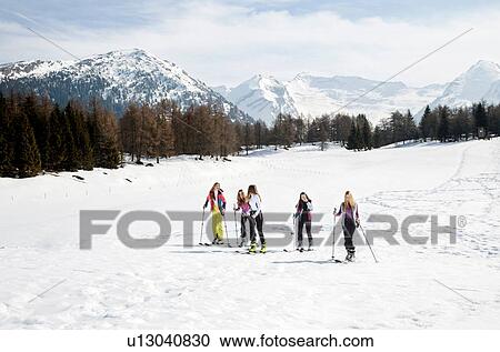 Stock Image - Five teenage girl skiers skiing on snow covered landscape, Tyrol, Styria, Austria. Fotosearch