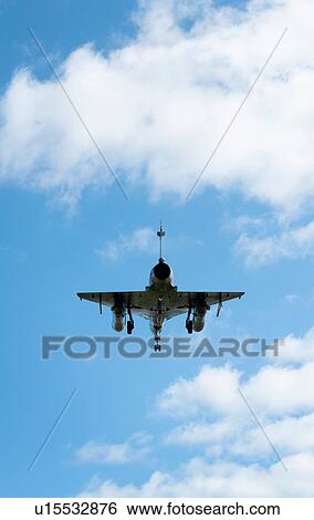 Stock Photograph - French Mirage 2000 fighter plane taking part in NATO exercise Frysian flag, low angle against blue sky, Netherlands. Fotosearch