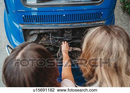 Stock Image - Friends fixing stalled car. Fotosearch