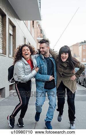 Friends laughing and playing on pavement, Milano, Lombardia, Italy View Large Photo Image Stock Image - Friends laughing and playing on pavement, Milano, Lombardia, Italy. Fotosearch
