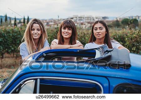 Friends posing beside car in countryside, Florence, Toscana, Italy View Large Photo Image Stock Image - Friends posing beside car in countryside, Florence, Toscana, Italy. Fotosearch