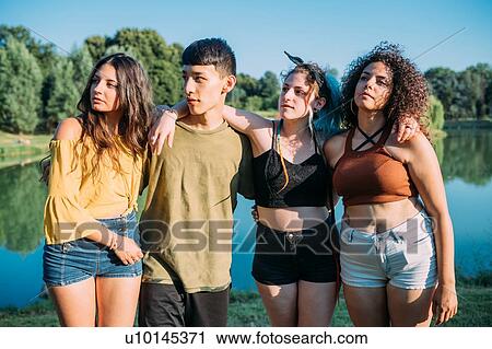 Friends posing by lake View Large Photo Image Stock Image - Friends posing by lake. Fotosearch