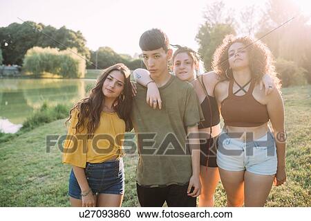 Friends posing by lake View Large Photo Image Stock Image - Friends posing by lake. Fotosearch