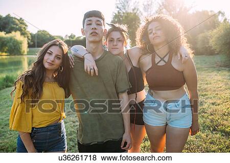 Stock Photo - Friends posing by lake. Fotosearch