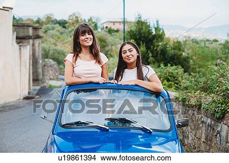 Picture - Friends posing in car sunroof, Florence, Toscana, Italy. Fotosearch