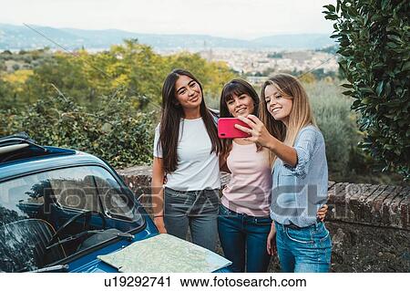 Stock Image - Friends taking selfie in countryside, Florence, Toscana, Italy. Fotosearch