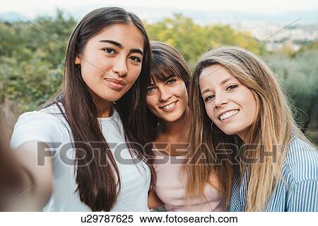 Stock Photography - Friends taking selfie in countryside. Fotosearch