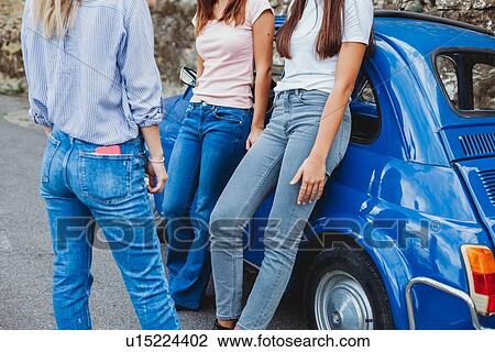 Friends talking beside car in countryside View Large Photo Image Stock Image - Friends talking beside car in countryside. Fotosearch