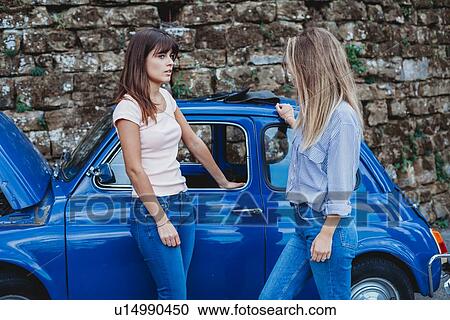 Friends talking beside stalled car in countryside View Large Photo Image Stock Image - Friends talking beside stalled car in countryside. Fotosearch