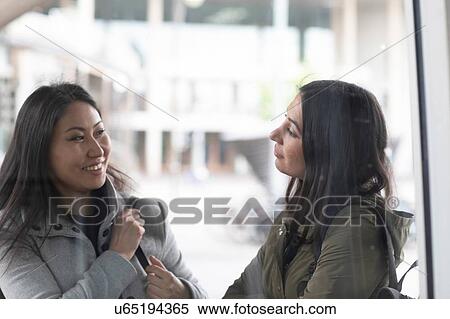 Friends talking in front of shop window View Large Photo Image Stock Photography - Friends talking in front of shop window. Fotosearch