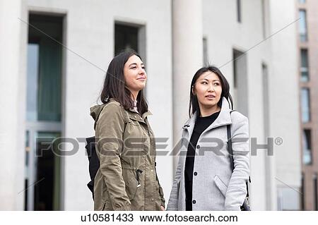 Friends waiting in front of building View Large Photo Image Stock Image - Friends waiting in front of building. Fotosearch