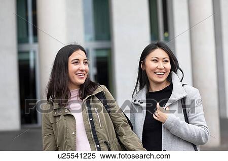 Friends waiting in front of building View Large Photo Image Stock Photography - Friends waiting in front of building. Fotosearch