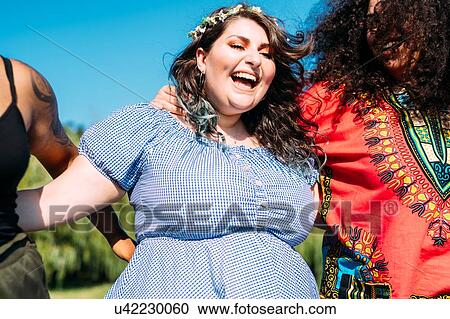 Stock Image - Friends walking in park. Fotosearch