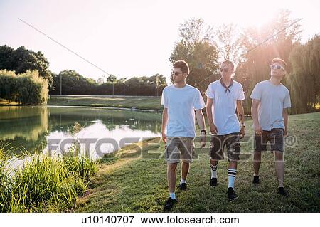 Stock Photo - Friends walking in park. Fotosearch