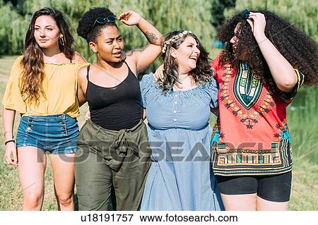 Stock Photo - Friends walking in park. Fotosearch