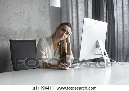 Frustrated businesswoman working at desktop computer View Large Photo Image Stock Image - Frustrated businesswoman working at desktop computer. Fotosearch