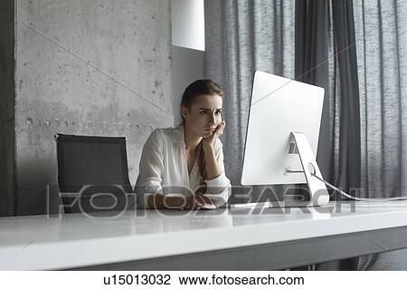 Frustrated businesswoman working at desktop computer View Large Photo Image Stock Image - Frustrated businesswoman working at desktop computer. Fotosearch